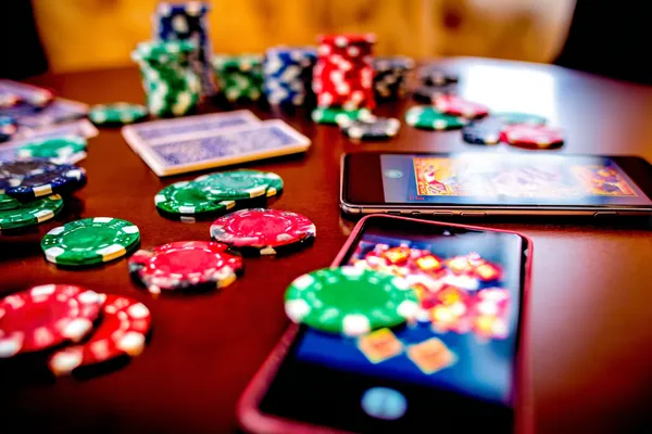 A professional dealer in a tuxedo greeting players at the roulette table, symbolizing the authentic live casino feel at 99XOBD.