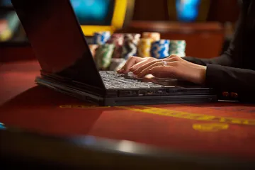 A glowing roulette wheel with cascading chips, symbolizing the engaging live and instant-win games available on 99XOBD.